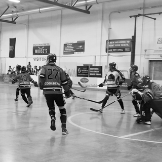 Men playing ball hockey at the provincials level.