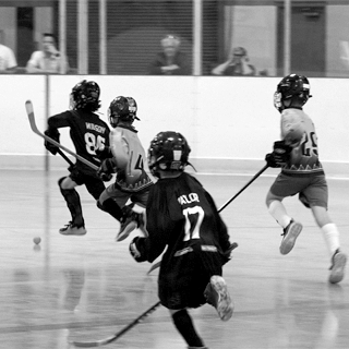 Minor players playing ball hockey.