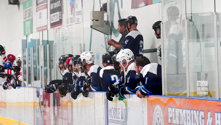 Goalie & teammates watching their game from the bench during a provincials tournament.