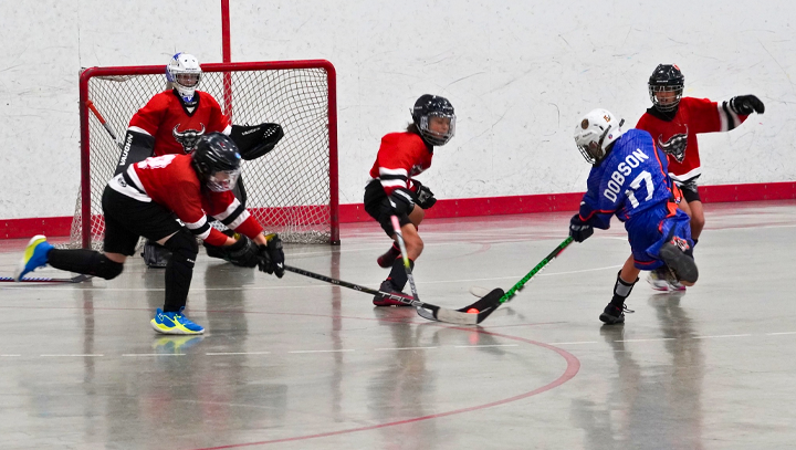 Goalie & teammates watching their game from the bench during a provincials tournament.