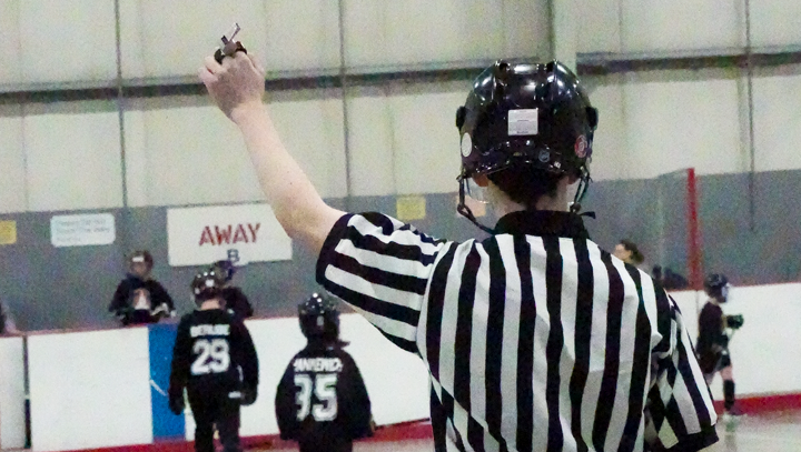 Goalie & teammates watching their game from the bench during a provincials tournament.