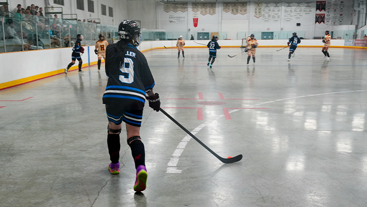 Goalie & teammates watching their game from the bench during a provincials tournament.
